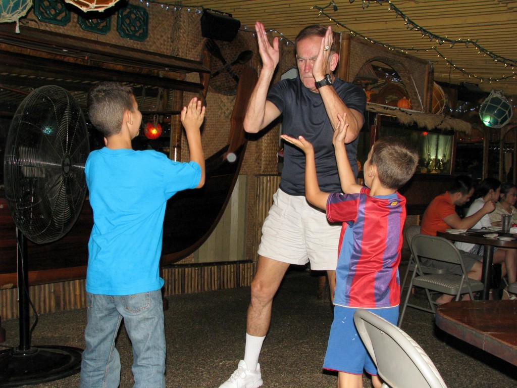 Steve, Conner, Ian dancing to Ron, who is blind,  playing on his keyboard.