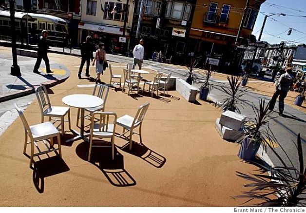 Built Dec 2008, a 7,800 sq ft corner where Castro & Market streets meet, half block of 17th, a turning lane onto Market & a small pediestrian island marked off. Bollards, chairs tables from Ikea, 11 granite slabs at end of streetcar line.