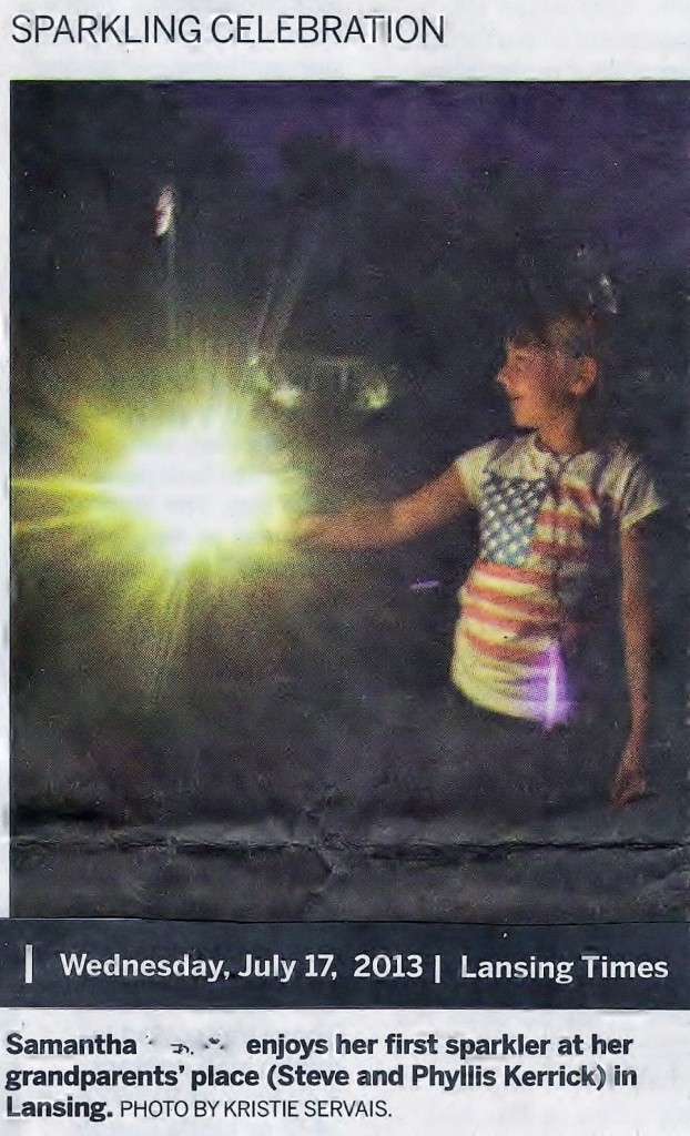 Samantha enjoying a sparkler at grandparents' home in Lansing