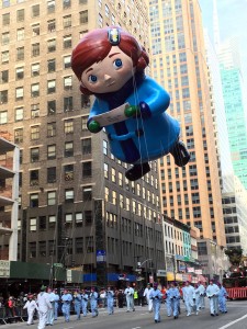 star of Macy's "Yes, Virginia" sweetly floats clutching her special letter. High as 3 story building, as wide as 4 taxi cabs, as long as 4 bicycles, 32 handlers.