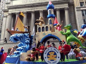 Castle featuring Build a Bear's icon Bearnard, serves as the centerpiece of this adventure themed float.Stars a friendly smoke breathing dragon climbing to see Princess Bear who shows crowd w/ confetti. Tea Party, trip to outer space by Astronaut bear.